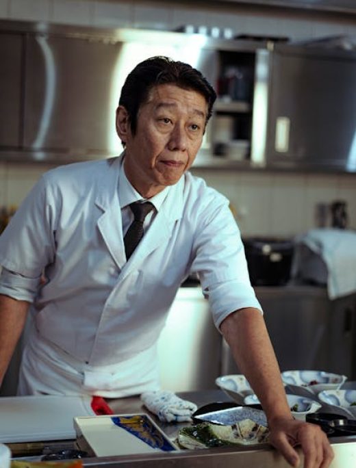 A skilled chef in a Tokyo kitchen preparing dishes, showcasing culinary expertise.